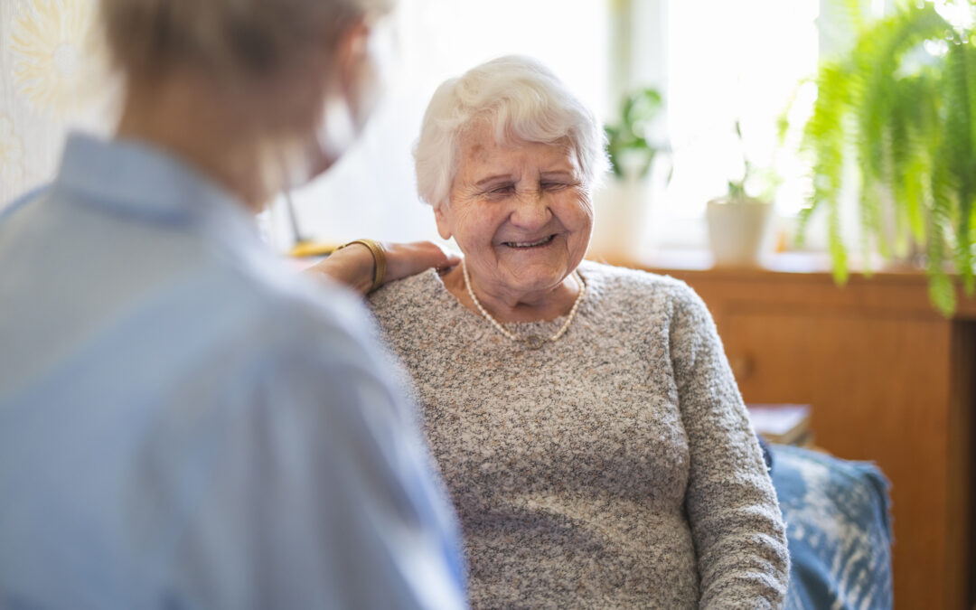 A caregiver offers emotional support to an elderly woman for switch-assisted-living blog.
